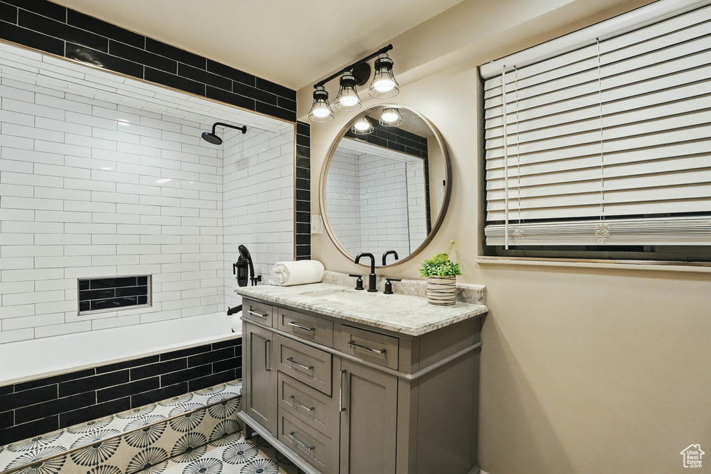 Full bath with vanity, tiled shower / bath, and tile patterned flooring