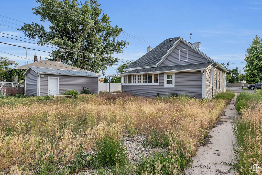 View of home's exterior with an outbuilding