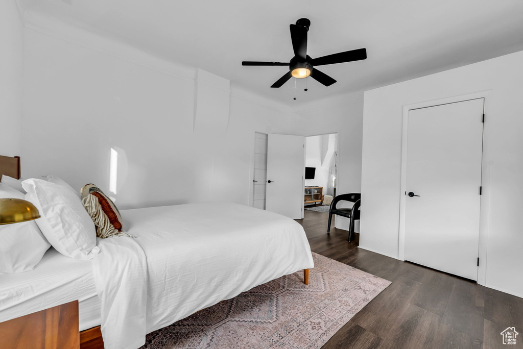 Bedroom with dark wood finished floors and ceiling fan