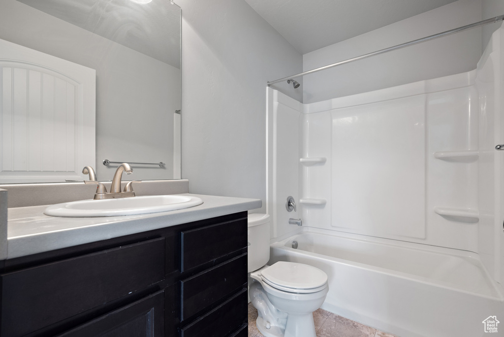 Full bath featuring toilet, vanity, and washtub / shower combination