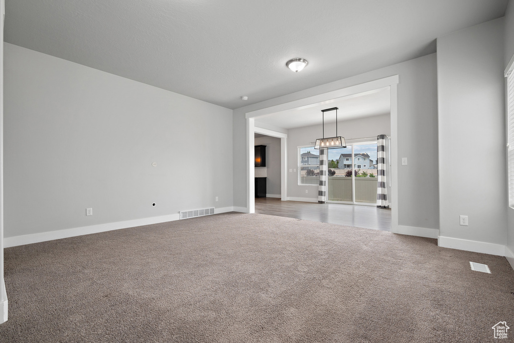Carpeted spare room with baseboards
