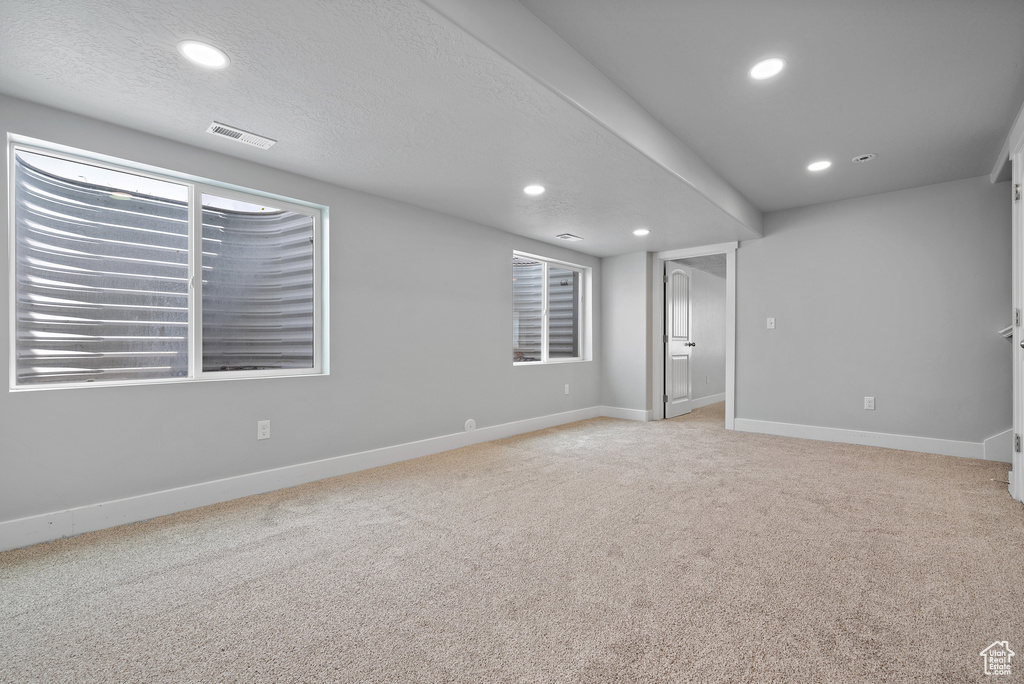 Spare room with carpet, recessed lighting, baseboards, and a textured ceiling