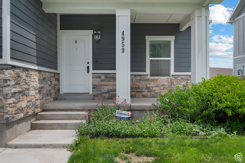 Property entrance featuring stone siding