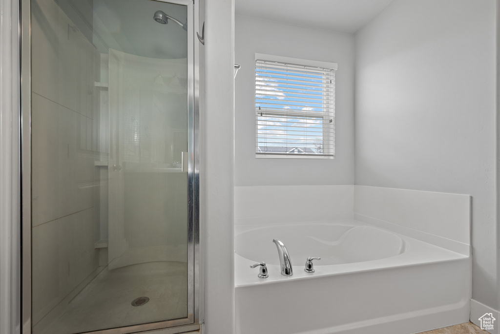 Full bath featuring a stall shower and a garden tub