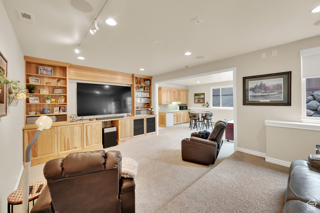 Living room featuring light carpet, baseboards, recessed lighting, and track lighting
