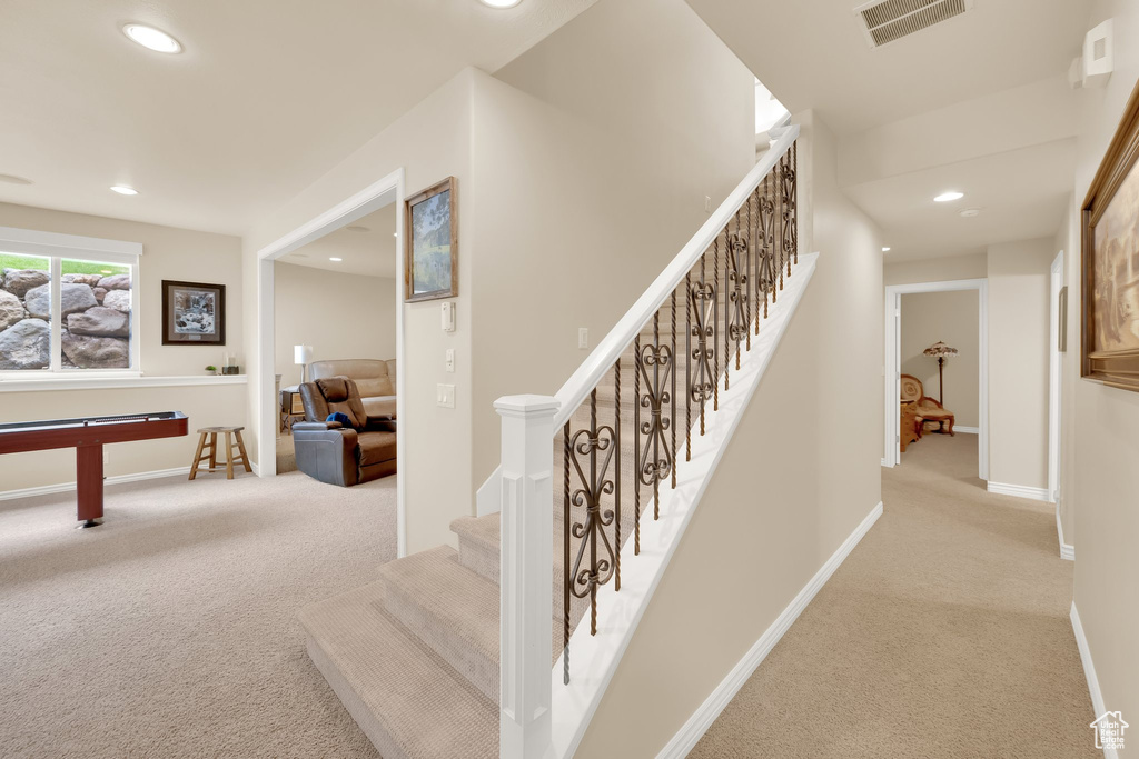 Stairway with carpet floors, recessed lighting, and baseboards