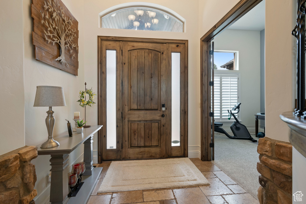 Entryway featuring stone tile flooring and baseboards