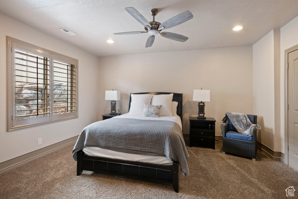 Carpeted bedroom with recessed lighting, a ceiling fan, baseboards, and a textured ceiling