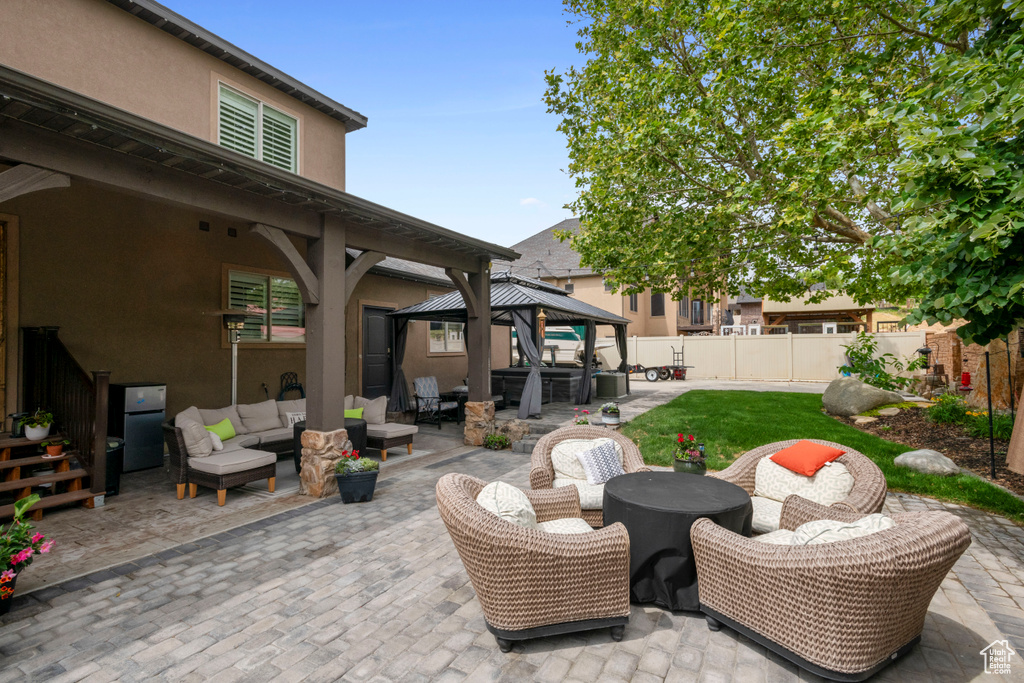 View of patio with a gazebo and an outdoor hangout area