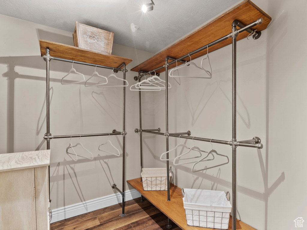 Walk in closet featuring wood finished floors