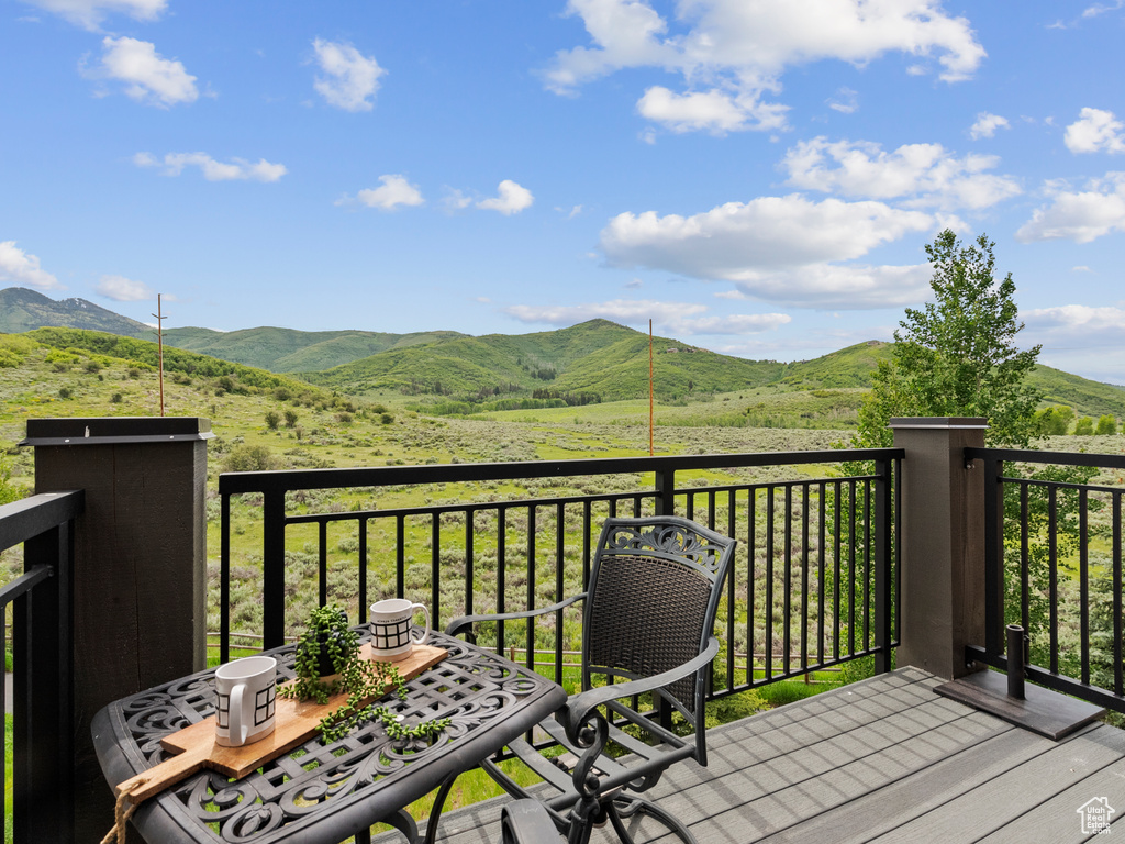 Balcony with a mountain view and outdoor dining area