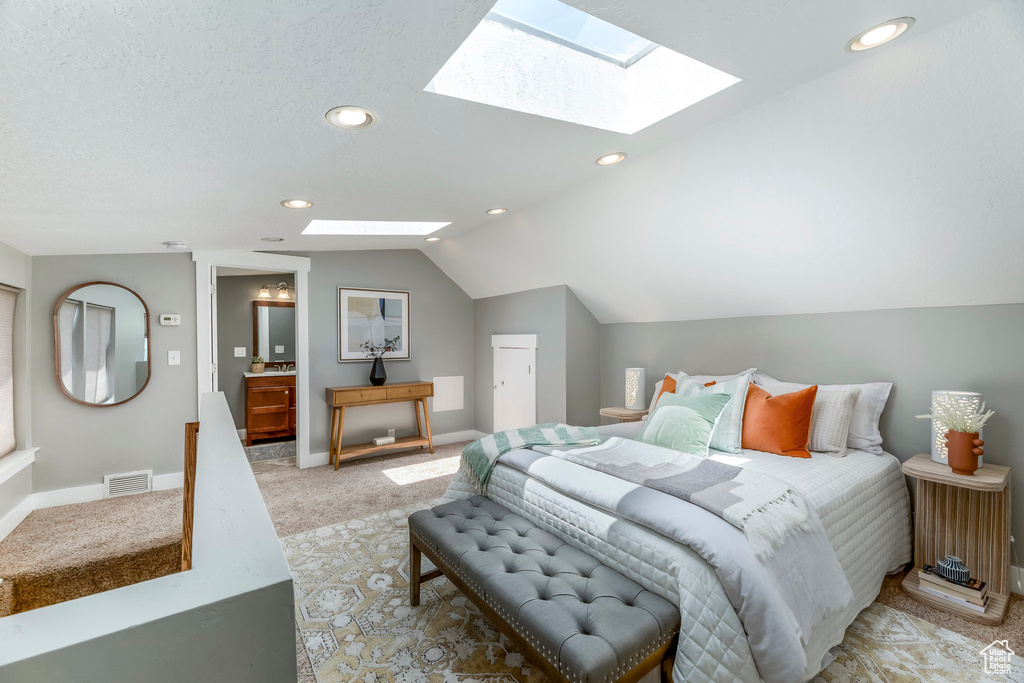 Bedroom with a skylight, light carpet, lofted ceiling, recessed lighting, and baseboards