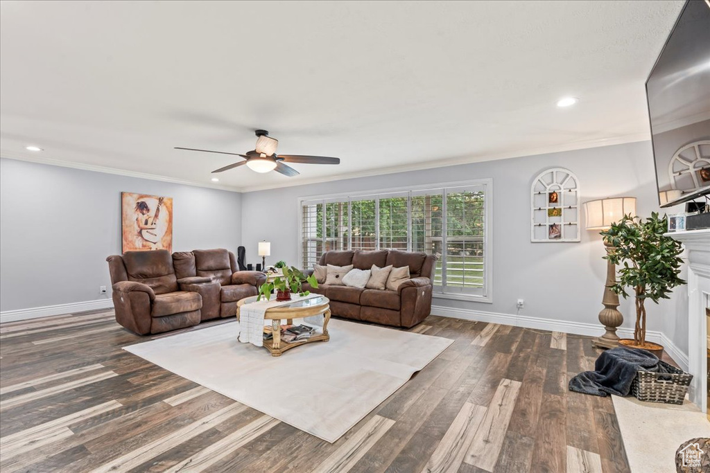 Living room featuring ceiling fan, dark wood finished floors, baseboards, recessed lighting, and ornamental molding