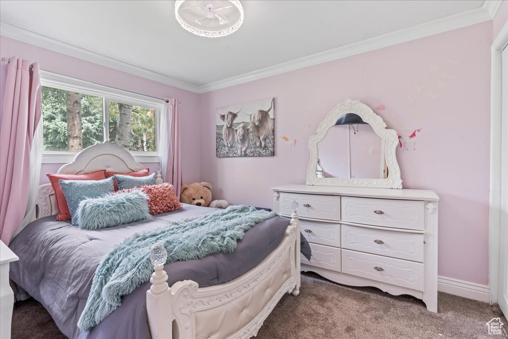 Carpeted bedroom with crown molding