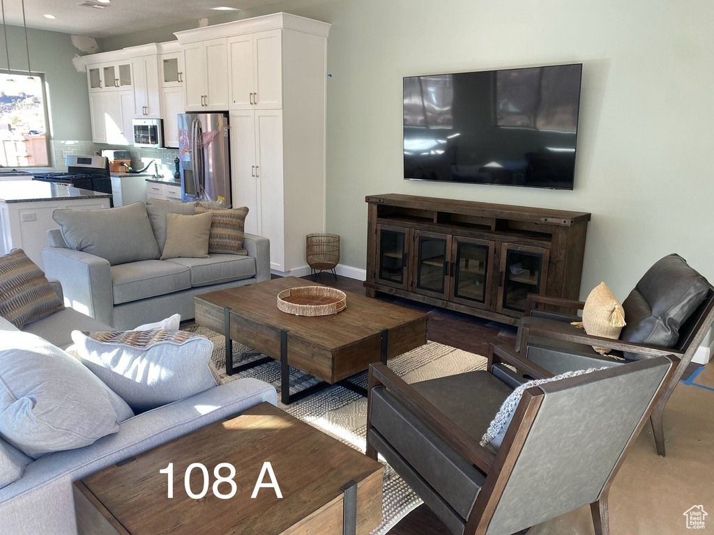 Living area with recessed lighting and baseboards