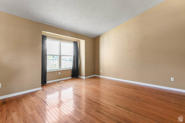 Empty room featuring light wood finished floors and baseboards