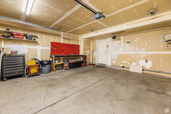 Garage with a workshop area and a garage door opener
