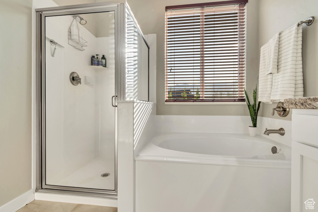 Full bathroom featuring a garden tub and a stall shower