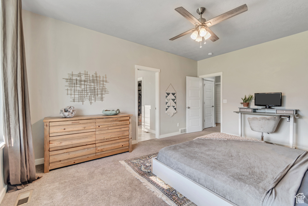 Bedroom with carpet flooring, baseboards, and a ceiling fan