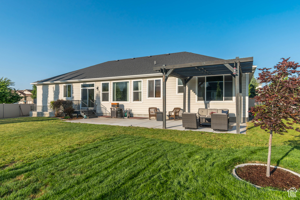 Rear view of house featuring entry steps, an outdoor hangout area, a patio, and a pergola