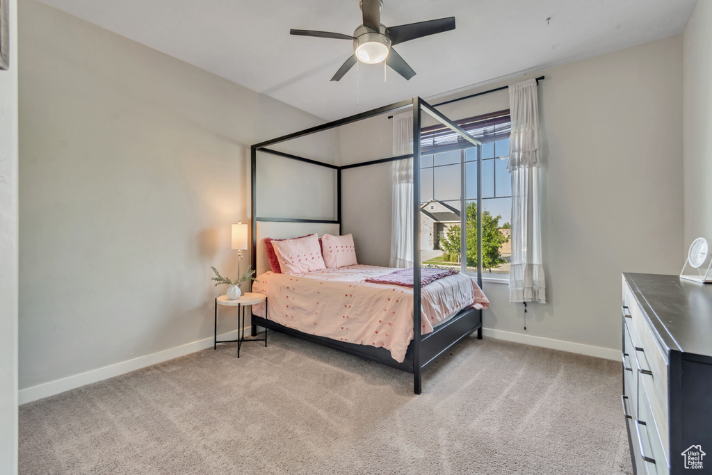 Bedroom featuring baseboards, carpet floors, and a ceiling fan