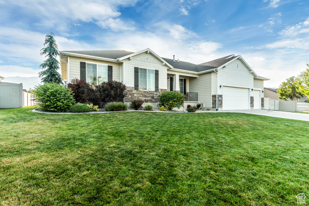 Single story home with a garage, stone siding, and concrete driveway