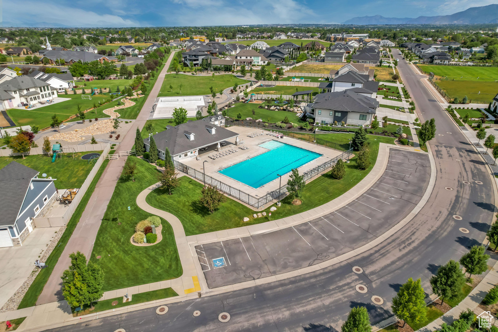 Aerial view of residential area featuring a pool area and mountains