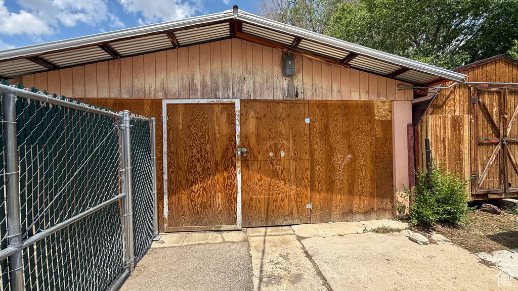 View of outdoor structure featuring a gate