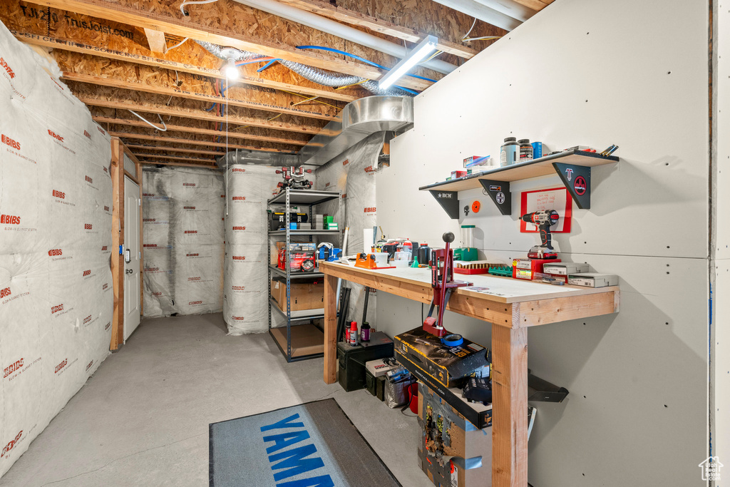 Unfinished below grade area featuring a workshop area