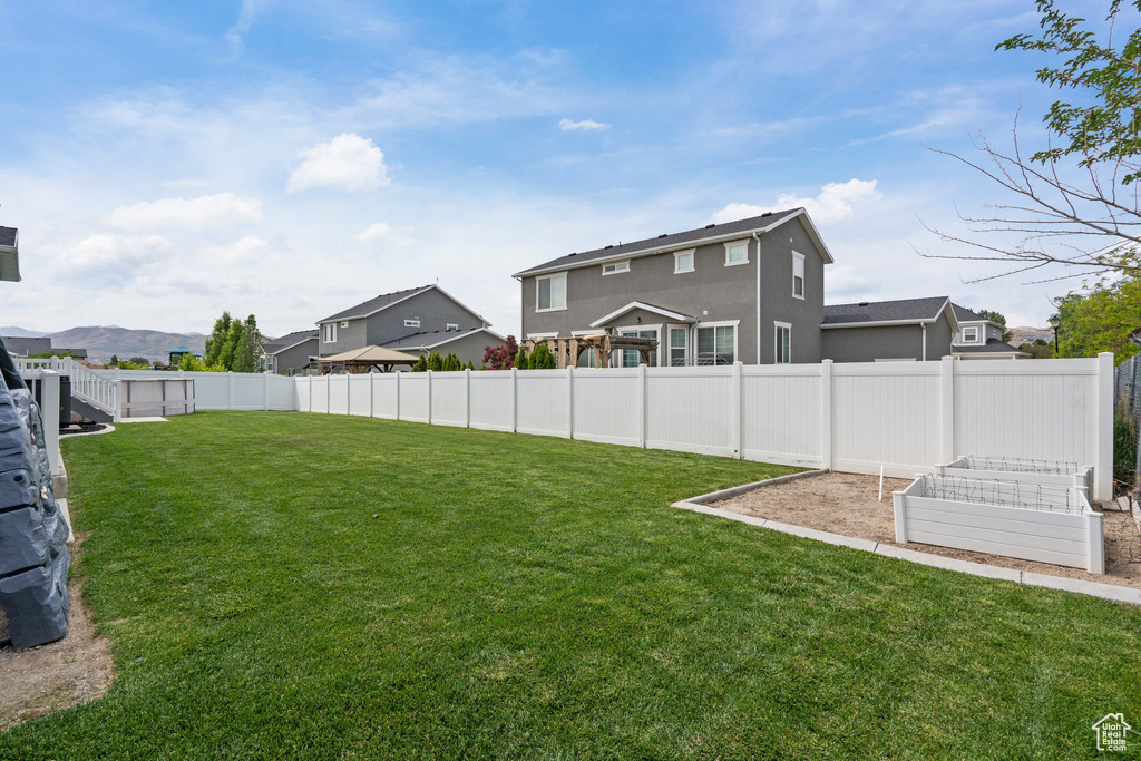 View of yard featuring a residential view and a garden