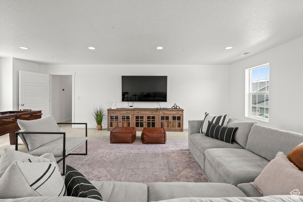 Carpeted living room with recessed lighting