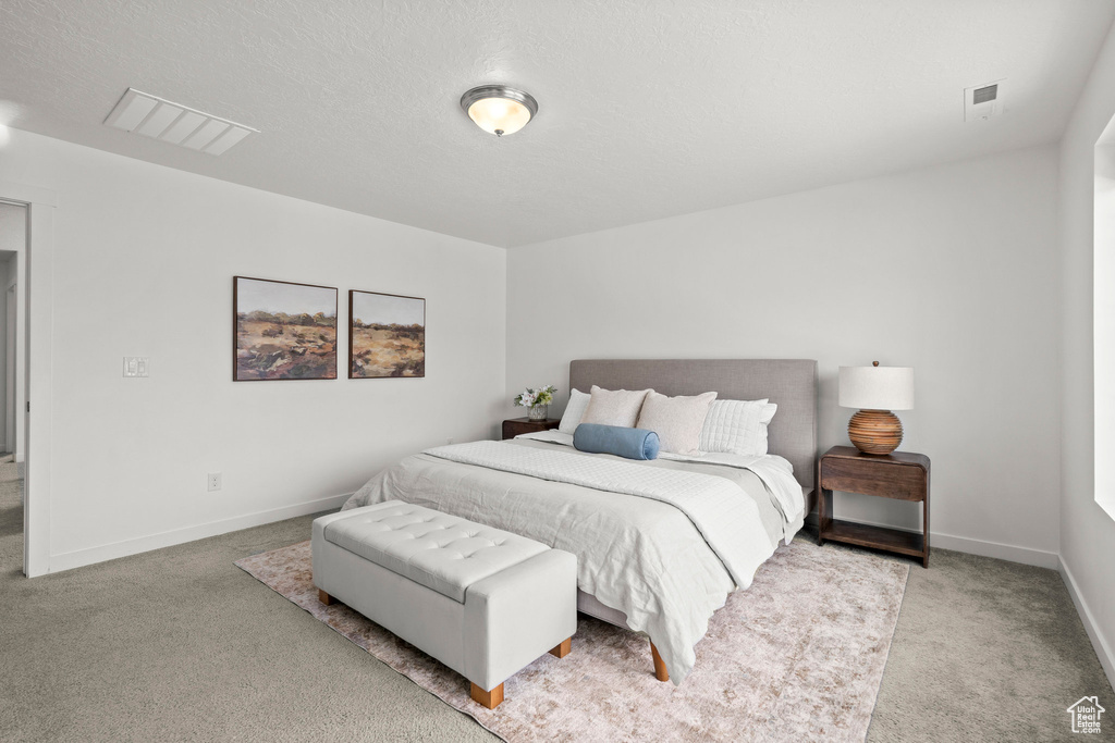 Carpeted bedroom featuring baseboards