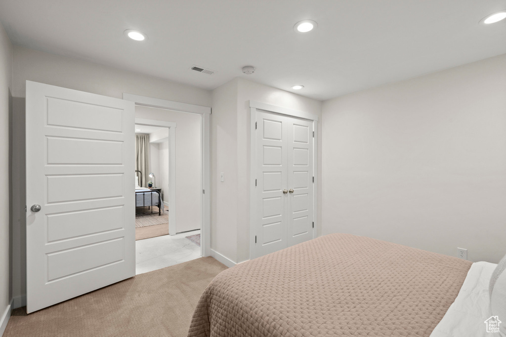 Bedroom featuring recessed lighting, a closet, light colored carpet, and baseboards