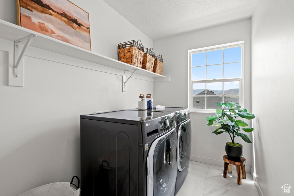 Laundry area with washing machine and dryer and baseboards