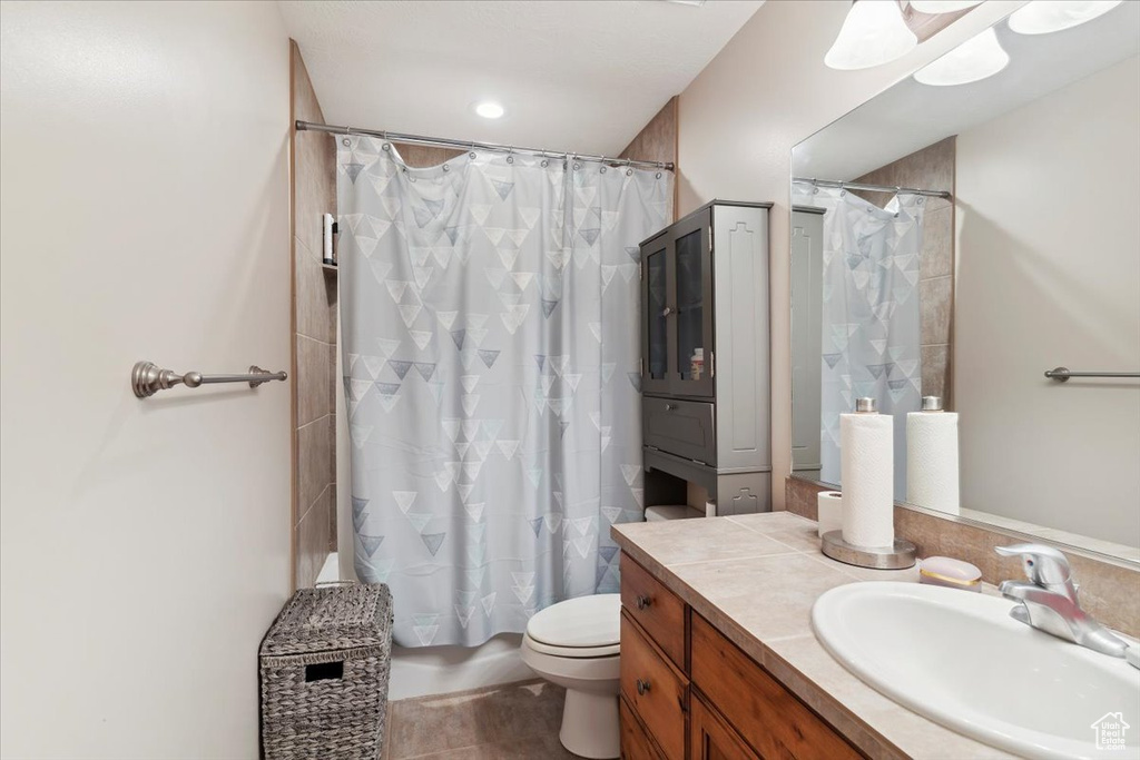 Bathroom with vanity, toilet, and shower / bath combo