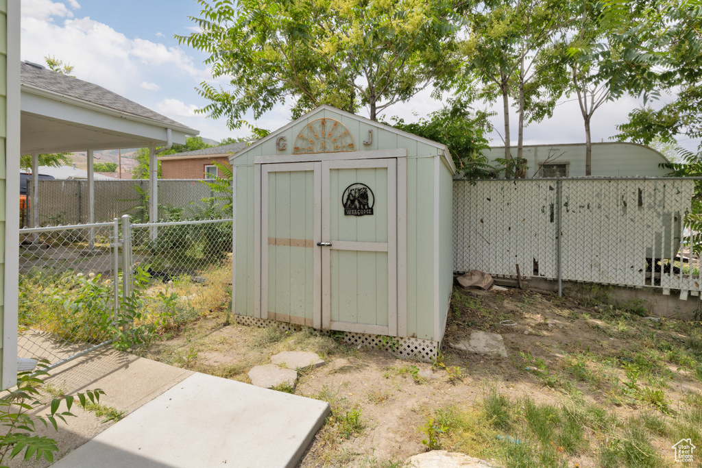 View of shed with a fenced backyard