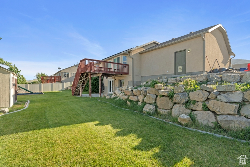 View of yard featuring stairway and a wooden deck