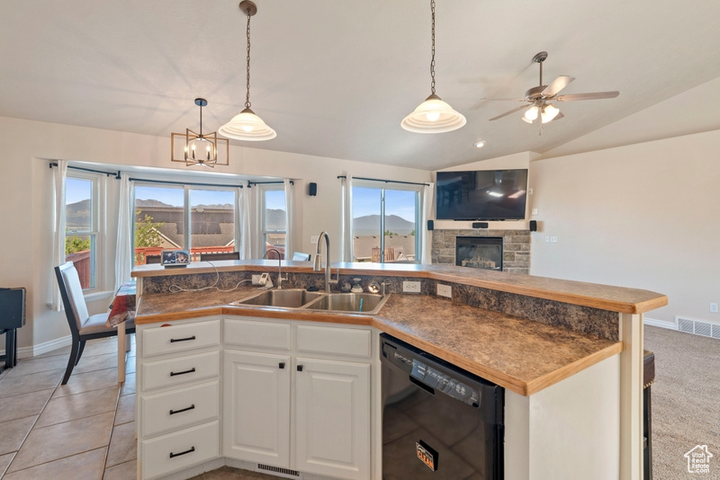 Kitchen featuring dishwasher, a sink, open floor plan, a kitchen island with sink, and a ceiling fan