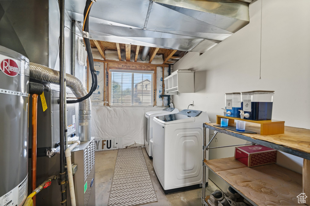 Washroom featuring washing machine and dryer and cabinet space