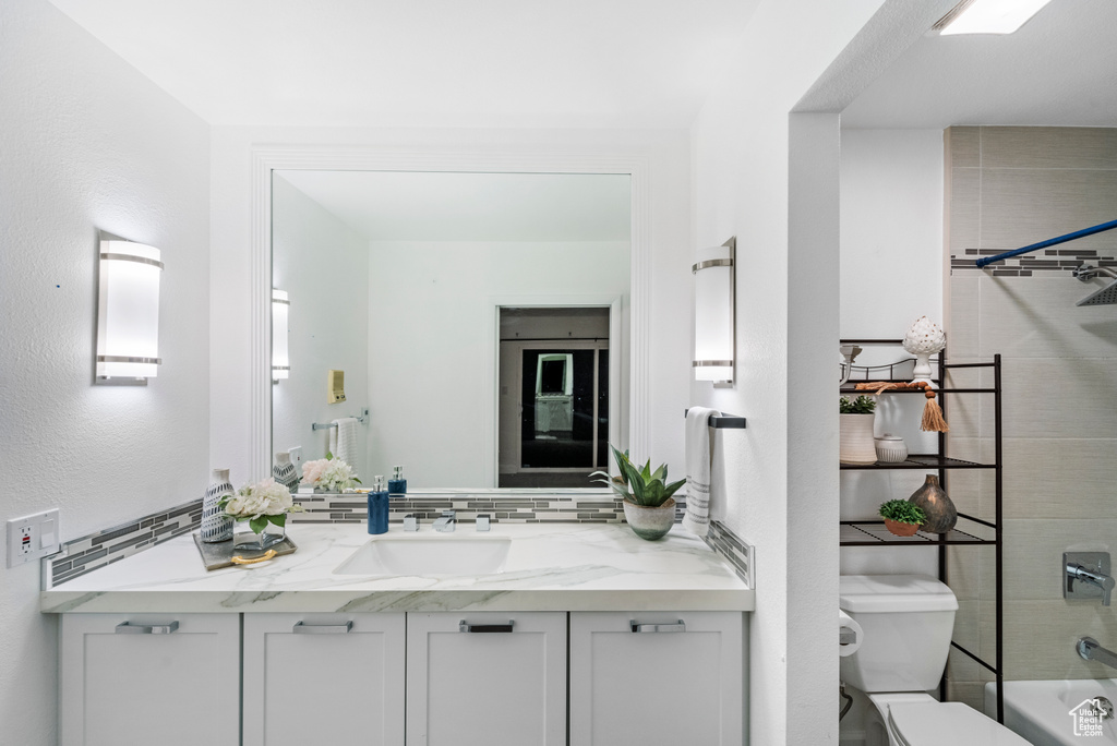 Full bath featuring vanity, toilet, and shower / washtub combination