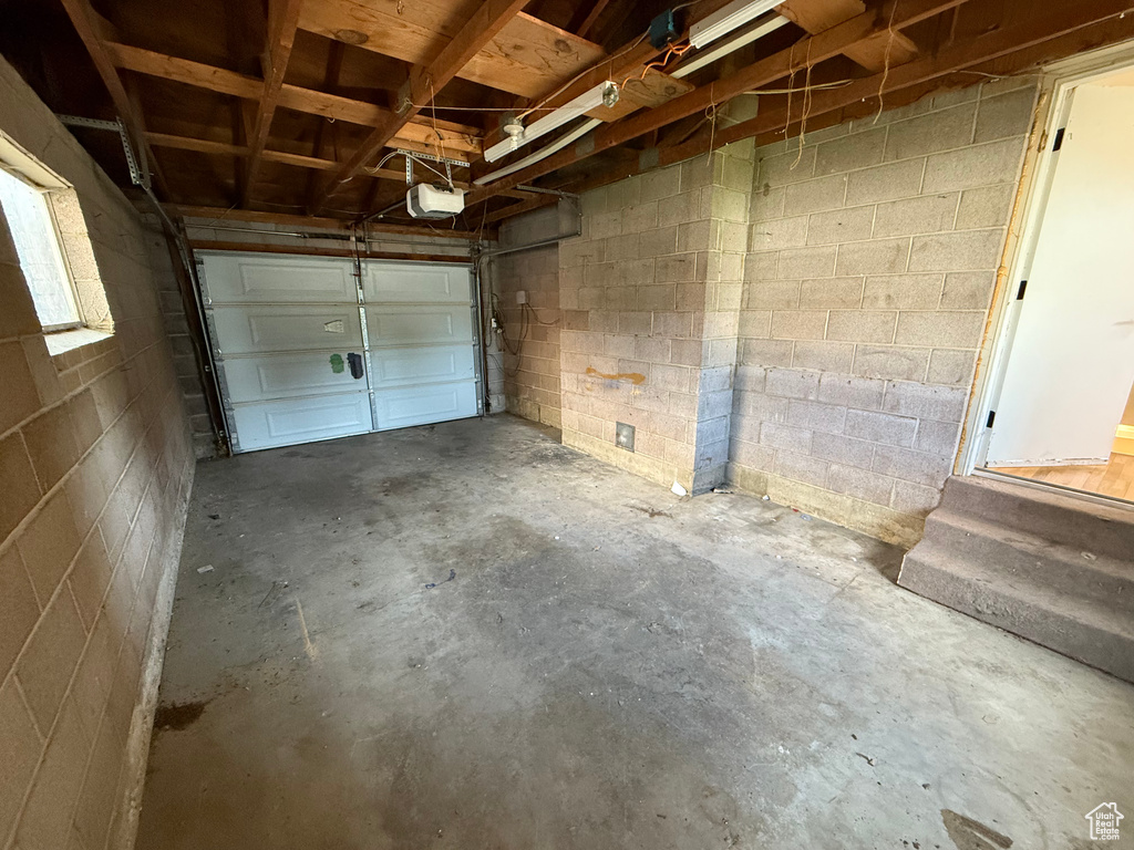 Garage with a garage door opener and concrete block wall