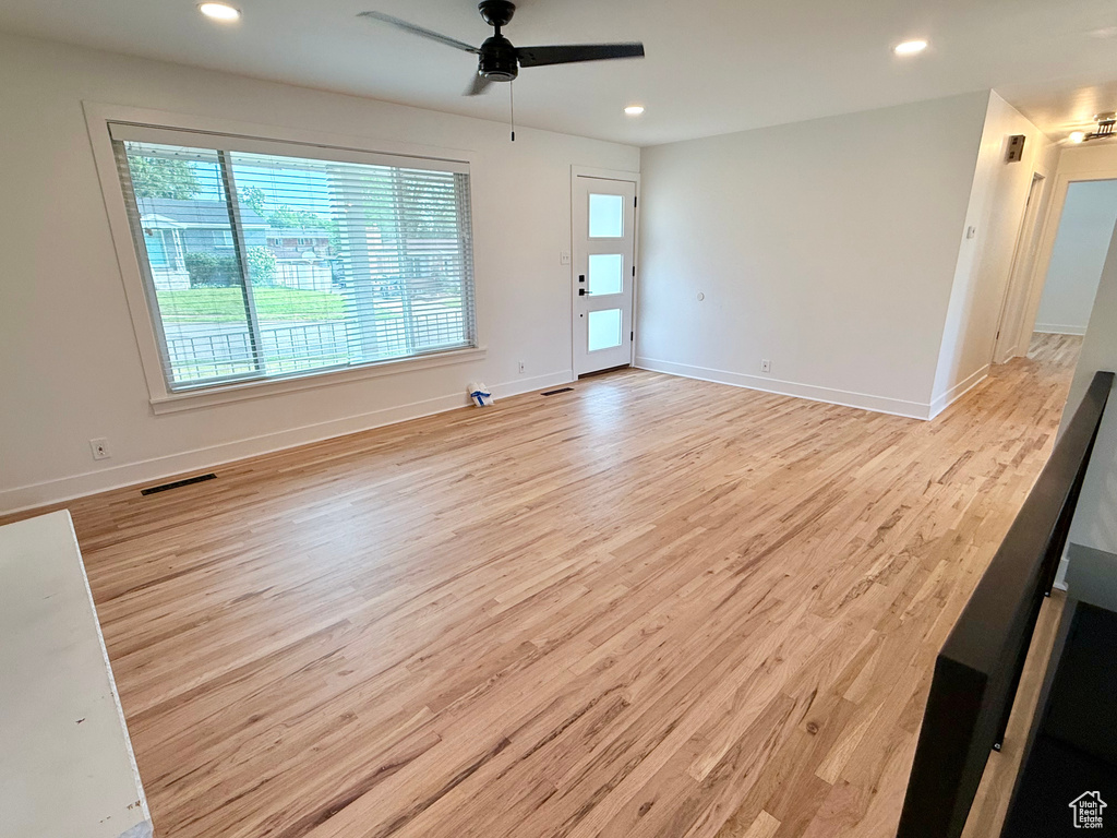 Unfurnished room with wood finished floors, a ceiling fan, recessed lighting, and baseboards