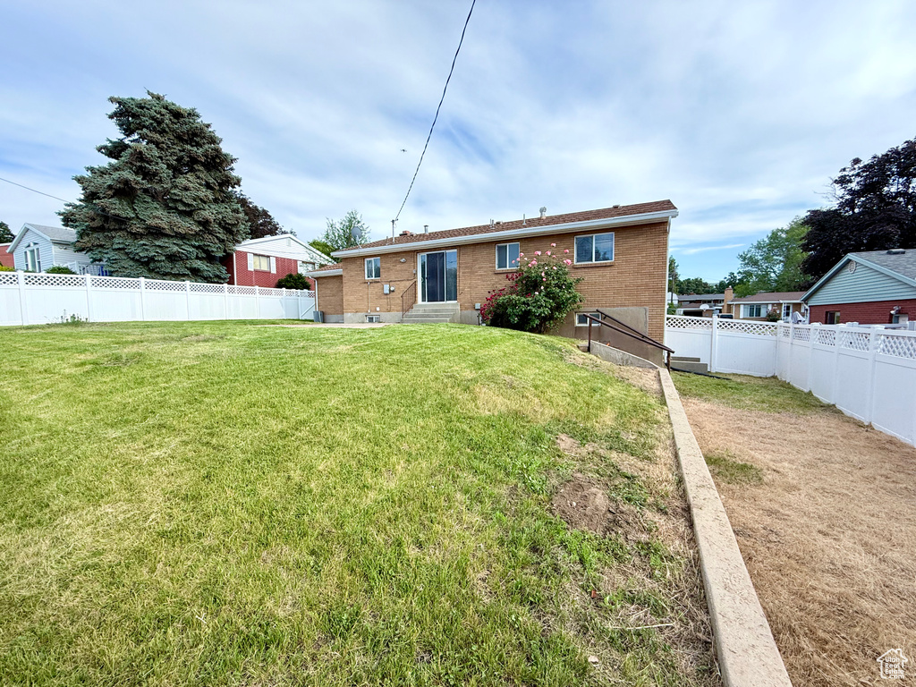 Back of house with entry steps and brick siding