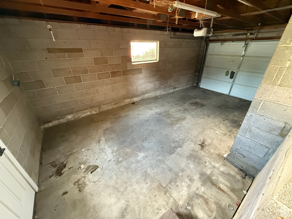 Garage with a garage door opener and concrete block wall