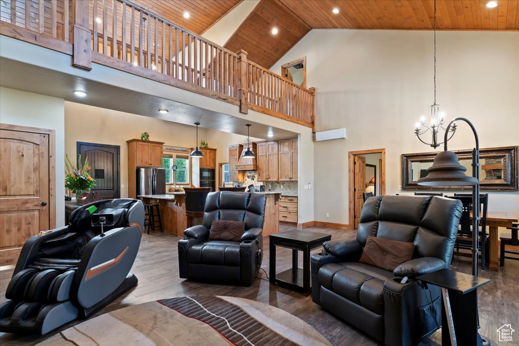 Living area with wood ceiling, a high ceiling, a chandelier, recessed lighting, and light wood finished floors