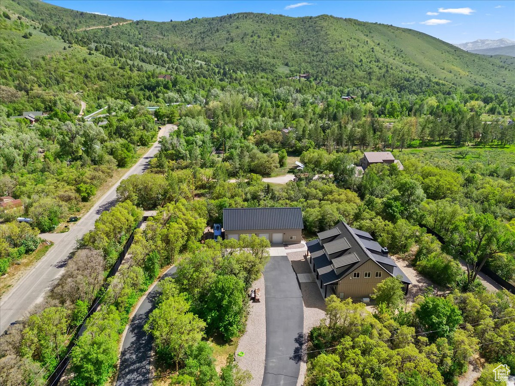 View from above of property with a forest and a mountain backdrop