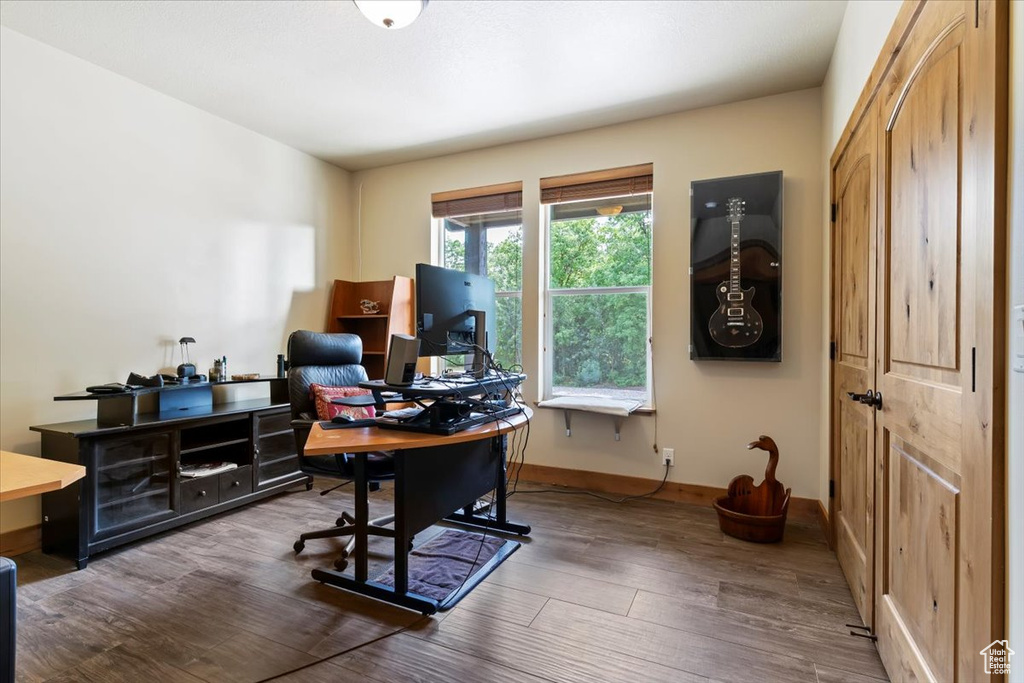 Home office featuring wood finished floors and baseboards