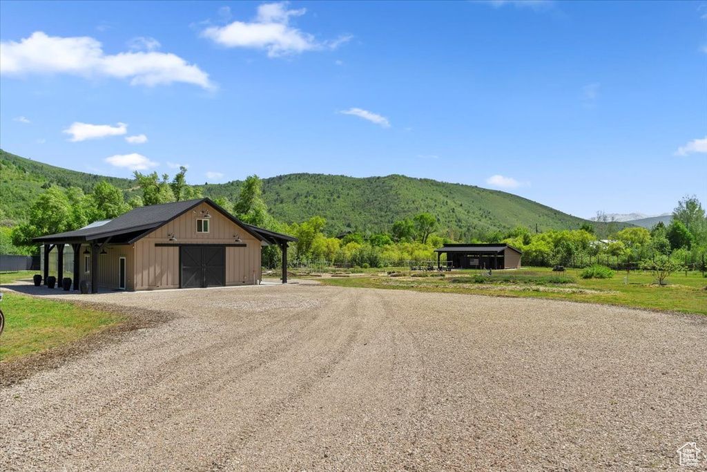 View of street with a mountain view and an outbuilding
