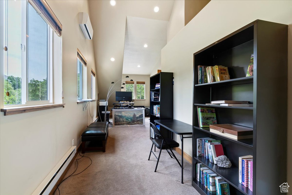 Carpeted office with a wall mounted AC, baseboard heating, and recessed lighting