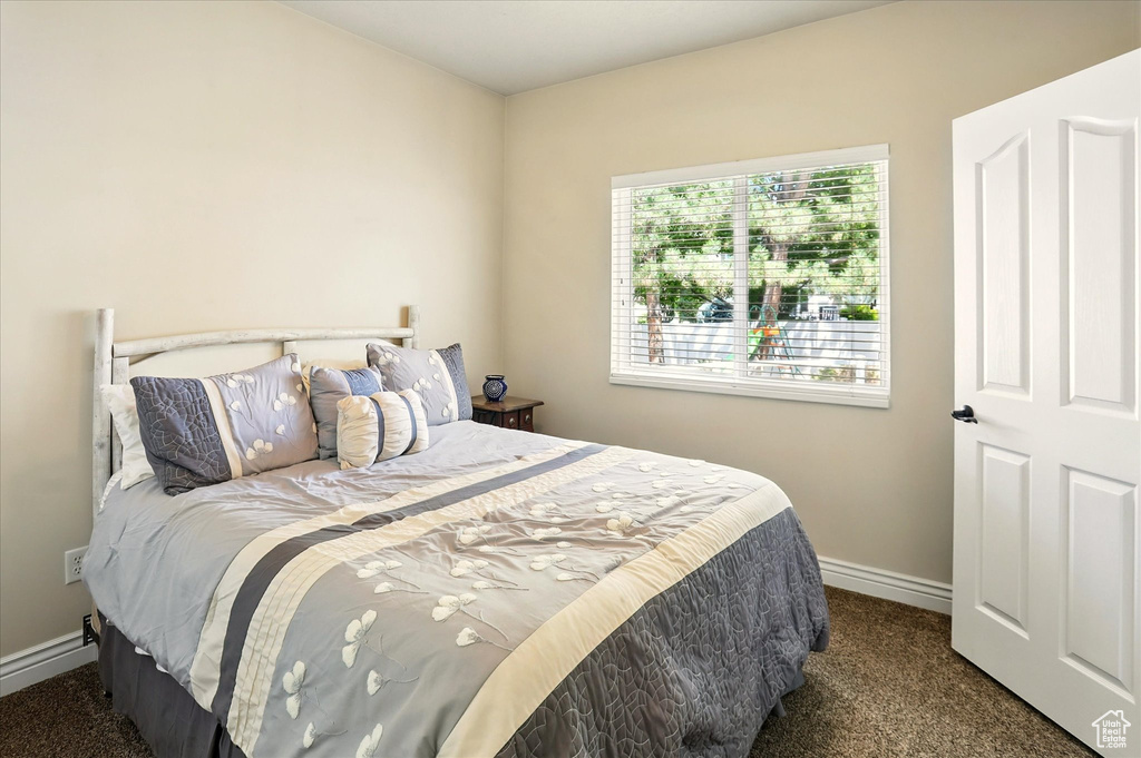 Bedroom featuring carpet flooring and baseboards